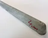 Szary, betonowy element, jeden z dystansów pod zbrojenie, z oznaczeniem "4 cm" na czerwono.