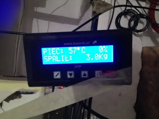 Wyświetlacz sterownika pieca na ekogroszek: PIEC: 57°C, SPALILIŁ: 3.0Kg. Automatyczne rozpalanie pieca na ekogroszek działa sprawnie.