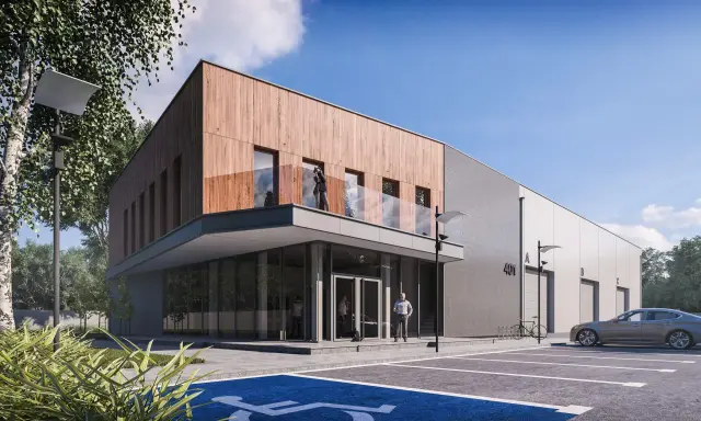 Nowoczesny budynek biurowy projekt z drewnianą elewacją i betonem. Przed budynkiem parking z miejscem dla niepełnosprawnych.